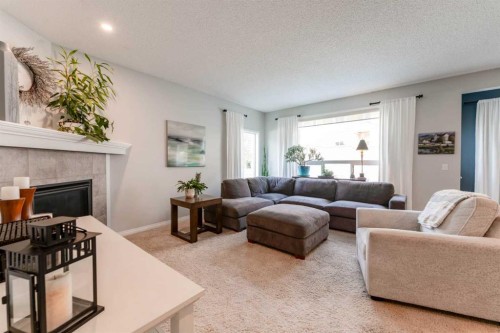 47 Panatella Bay Nw, Calgary, AB - Indoor Photo Showing Living Room With Fireplace