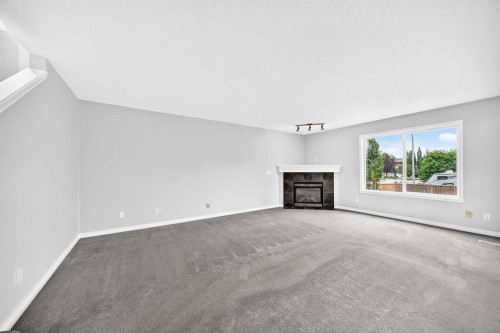 171 Oakmere Green, Chestermere, AB - Indoor Photo Showing Living Room With Fireplace