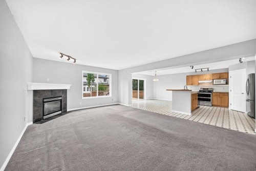 171 Oakmere Green, Chestermere, AB - Indoor Photo Showing Other Room With Fireplace