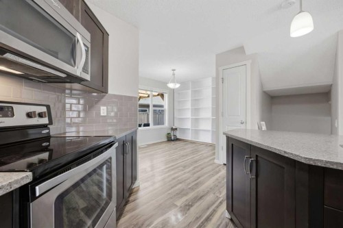 93 Sunvalley Road, Cochrane, AB - Indoor Photo Showing Kitchen With Upgraded Kitchen