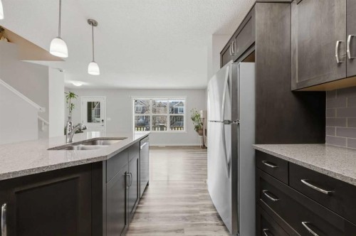 93 Sunvalley Road, Cochrane, AB - Indoor Photo Showing Kitchen With Double Sink