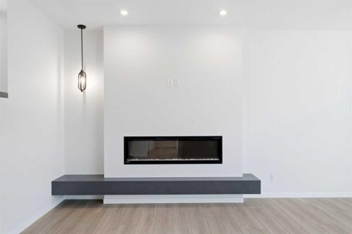 572 Belmont Heath Sw, Calgary, AB - Indoor Photo Showing Living Room With Fireplace