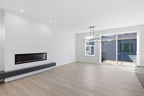 572 Belmont Heath Sw, Calgary, AB - Indoor Photo Showing Living Room With Fireplace