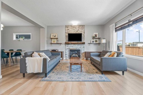 6 Storm Mountain Place, Okotoks, AB - Indoor Photo Showing Living Room With Fireplace