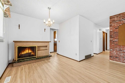 3803 14 Avenue Ne, Calgary, AB - Indoor Photo Showing Living Room With Fireplace