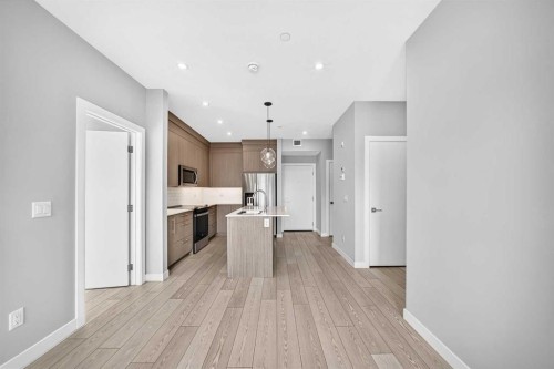 2110-6 Merganser Drive West, Chestermere, AB - Indoor Photo Showing Kitchen With Stainless Steel Kitchen