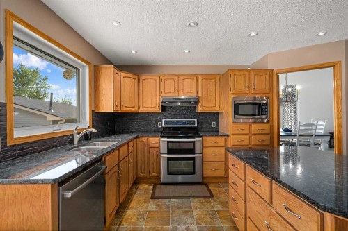 1114 Whitfield Avenue, Crossfield, AB - Indoor Photo Showing Kitchen With Double Sink