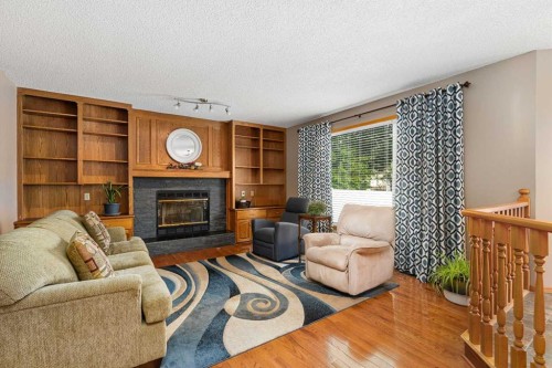 1114 Whitfield Avenue, Crossfield, AB - Indoor Photo Showing Living Room With Fireplace