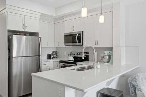 413-20 Seton Park Se, Calgary, AB - Indoor Photo Showing Kitchen With Double Sink With Upgraded Kitchen