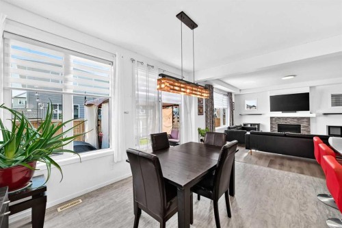 188 Carrington Crescent Nw, Calgary, AB - Indoor Photo Showing Dining Room With Fireplace