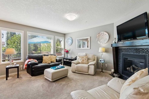 768 New Brighton Drive Se, Calgary, AB - Indoor Photo Showing Living Room With Fireplace