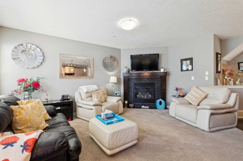 768 New Brighton Drive Se, Calgary, AB - Indoor Photo Showing Living Room With Fireplace