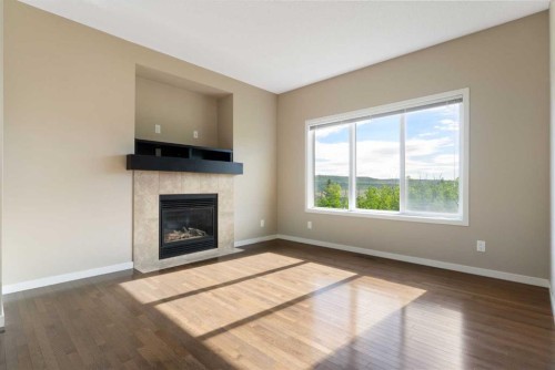 638 River Heights Crescent, Cochrane, AB - Indoor Photo Showing Living Room With Fireplace
