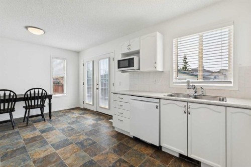 25 Coville Gardens Ne, Calgary, AB - Indoor Photo Showing Kitchen With Double Sink