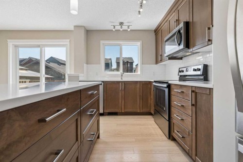 229 Fireside Drive, Cochrane, AB - Indoor Photo Showing Kitchen With Upgraded Kitchen