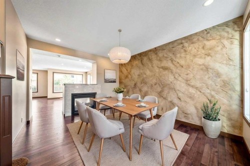 183 Cranford Green Se, Calgary, AB - Indoor Photo Showing Dining Room With Fireplace