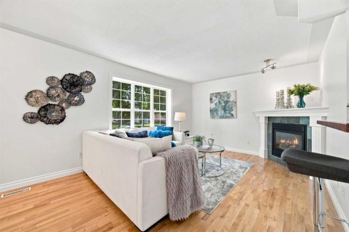 172 Somme Manor Sw, Calgary, AB - Indoor Photo Showing Living Room With Fireplace