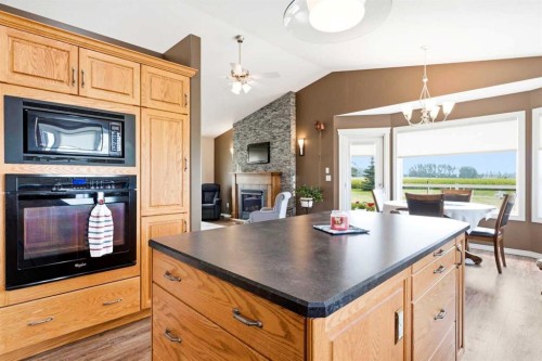 34055 Range Road 24, Rural Mountain View County, AB - Indoor Photo Showing Kitchen With Fireplace