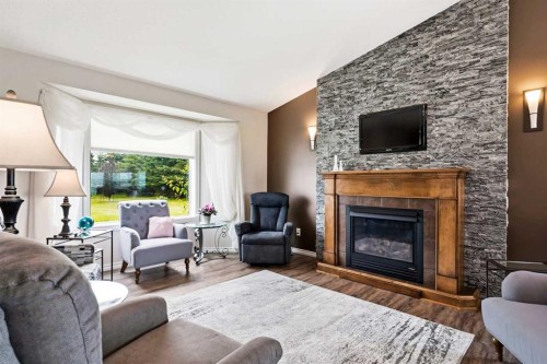 34055 Range Road 24, Rural Mountain View County, AB - Indoor Photo Showing Living Room With Fireplace