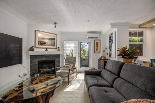 106-59 22 Avenue Sw, Calgary, AB - Indoor Photo Showing Living Room With Fireplace