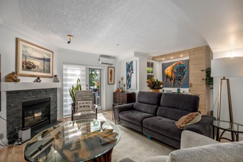 106-59 22 Avenue Sw, Calgary, AB - Indoor Photo Showing Living Room With Fireplace