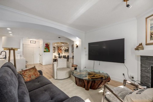 106-59 22 Avenue Sw, Calgary, AB - Indoor Photo Showing Living Room With Fireplace