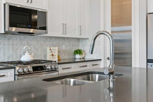 363 Precedence Hill, Cochrane, AB - Indoor Photo Showing Kitchen With Stainless Steel Kitchen With Double Sink With Upgraded Kitchen