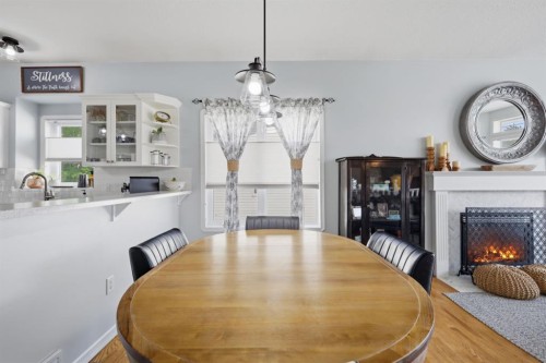6103 58 Street, Olds, AB - Indoor Photo Showing Dining Room With Fireplace