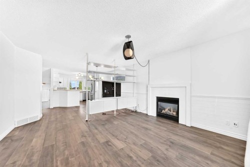 708 Tuscany Drive Nw, Calgary, AB - Indoor Photo Showing Living Room With Fireplace