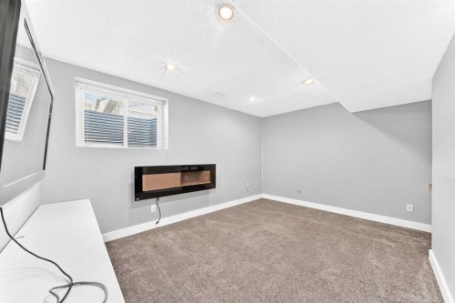 708 Tuscany Drive Nw, Calgary, AB - Indoor Photo Showing Other Room With Fireplace