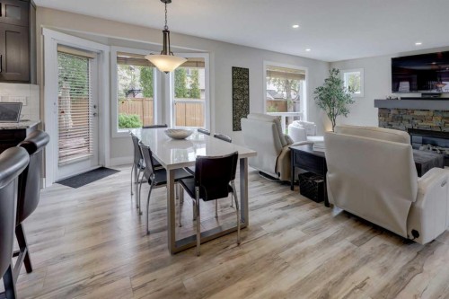 8 Canoe Road Sw, Airdrie, AB - Indoor Photo Showing Dining Room With Fireplace