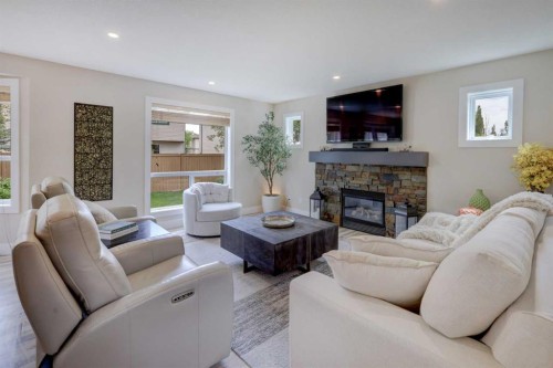8 Canoe Road Sw, Airdrie, AB - Indoor Photo Showing Living Room With Fireplace