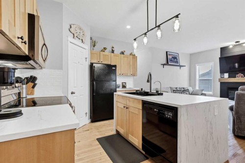 738 Carriage Lane Drive, Carstairs, AB - Indoor Photo Showing Kitchen With Fireplace