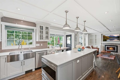 606 Schubert Place Nw, Calgary, AB - Indoor Photo Showing Kitchen With Fireplace With Double Sink