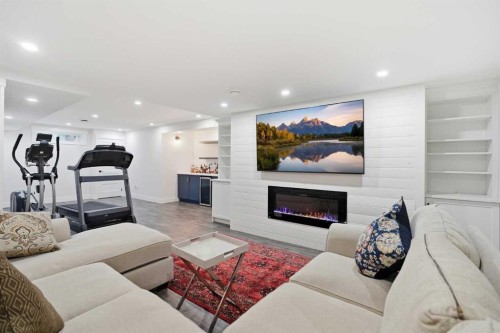 606 Schubert Place Nw, Calgary, AB - Indoor Photo Showing Living Room With Fireplace