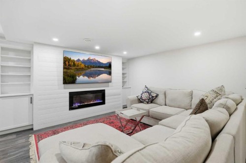 606 Schubert Place Nw, Calgary, AB - Indoor Photo Showing Living Room With Fireplace
