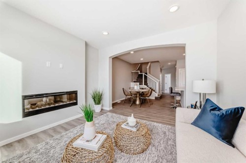 136 Heirloom Street Se, Calgary, AB - Indoor Photo Showing Living Room With Fireplace