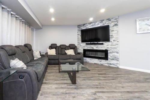 47 Everstone Boulevard Sw, Calgary, AB - Indoor Photo Showing Living Room With Fireplace
