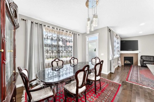 56 Evansborough Green Nw, Calgary, AB - Indoor Photo Showing Dining Room With Fireplace