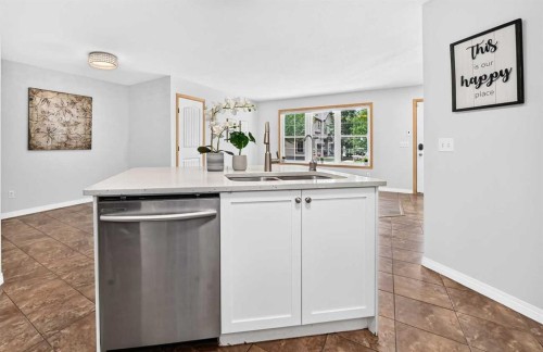 103-160 Panatella Landing Nw, Calgary, AB - Indoor Photo Showing Kitchen With Double Sink