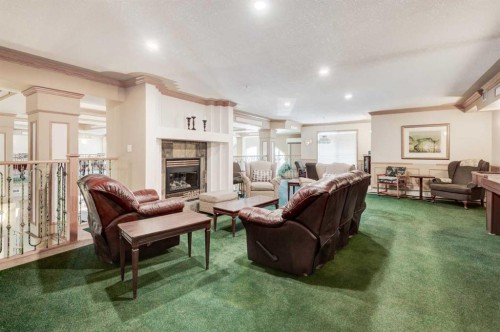 304-728 Country Hills Road Nw, Calgary, AB - Indoor Photo Showing Living Room With Fireplace
