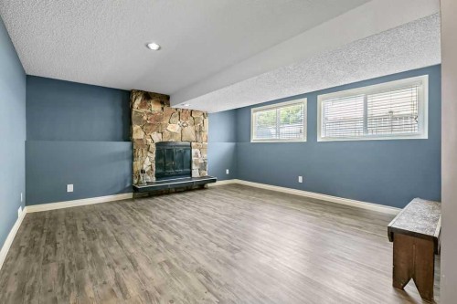 163 Woodburn Crescent, Okotoks, AB - Indoor Photo Showing Other Room With Fireplace
