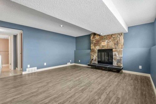163 Woodburn Crescent, Okotoks, AB - Indoor Photo Showing Living Room With Fireplace