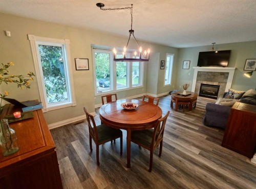 672 Killarney Glen Court Sw, Calgary, AB - Indoor Photo Showing Dining Room With Fireplace