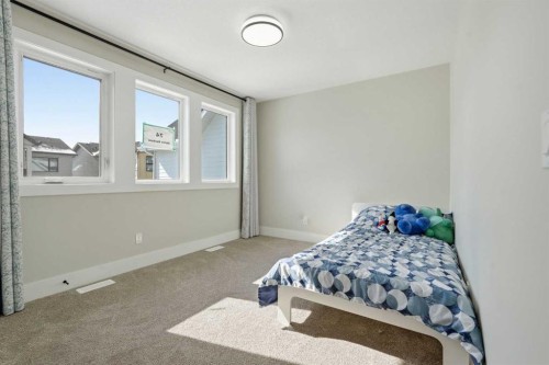 74 Alpine Gardens Sw, Calgary, AB - Indoor Photo Showing Bedroom