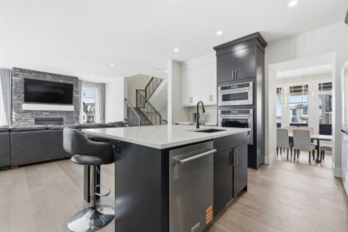 74 Alpine Gardens Sw, Calgary, AB - Indoor Photo Showing Kitchen With Fireplace With Stainless Steel Kitchen With Upgraded Kitchen
