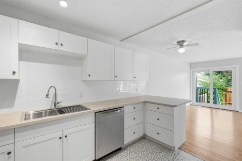 4-126 Mcrae Street, Okotoks, AB - Indoor Photo Showing Kitchen With Double Sink