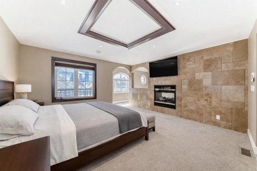 1108 Bellevue Avenue Se, Calgary, AB - Indoor Photo Showing Bedroom With Fireplace