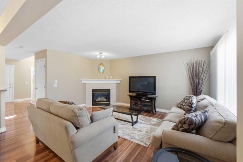 140 Arbour Stone Crescent Nw, Calgary, AB - Indoor Photo Showing Living Room With Fireplace