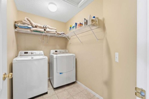 140 Arbour Stone Crescent Nw, Calgary, AB - Indoor Photo Showing Laundry Room